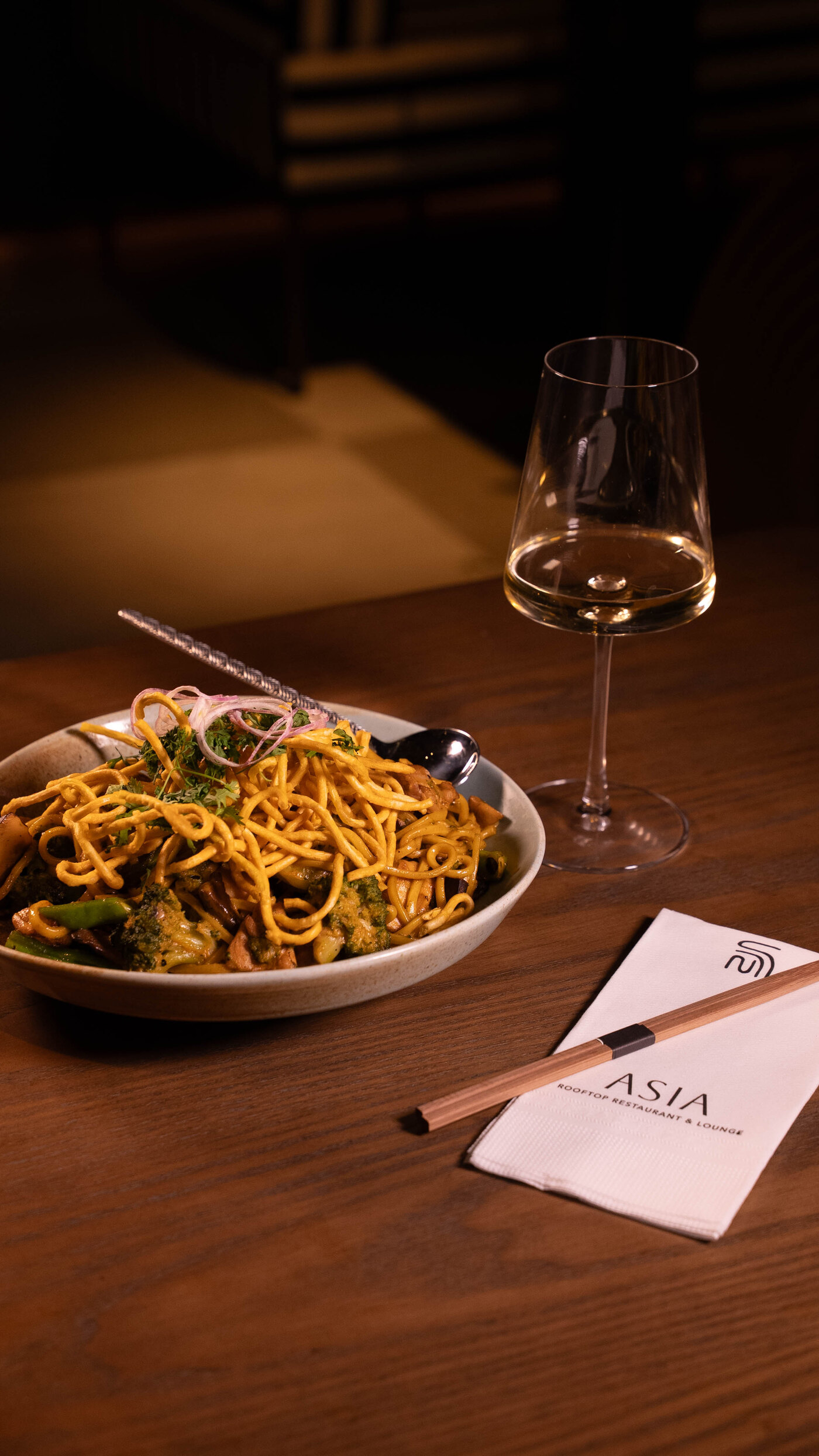 ASIA Restaurant — noodles and a glass of white wine on the table