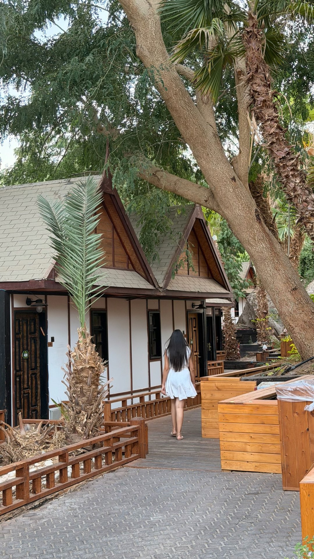 A guest crossing in front of the wooden building