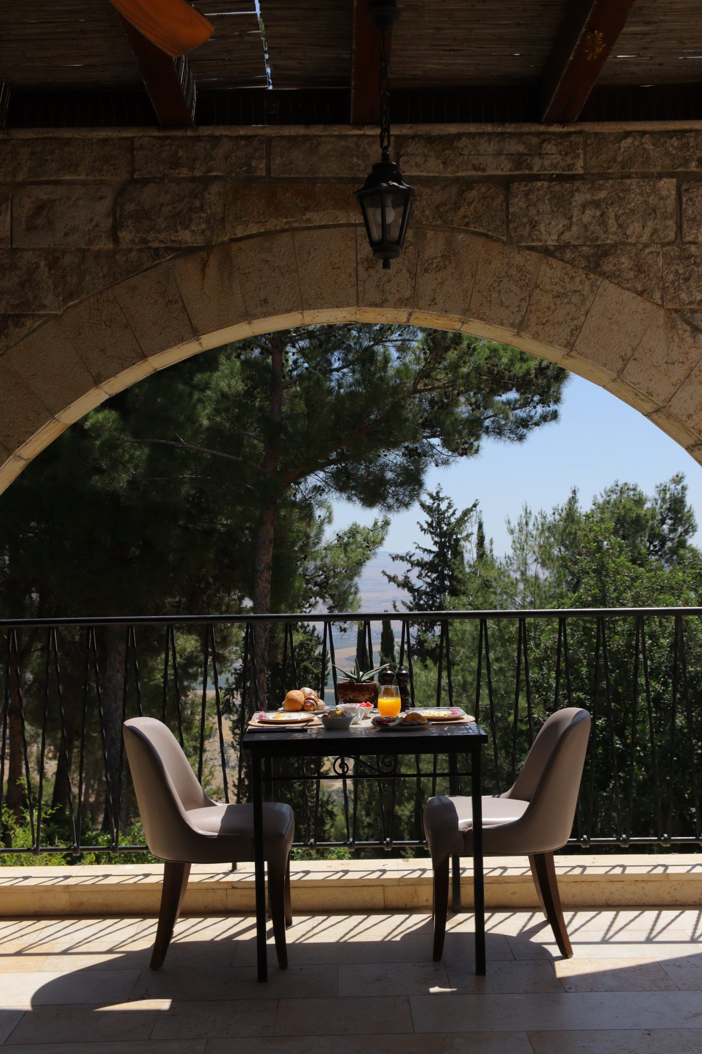 Breakfast laid out under the stone arch, the forest beyond