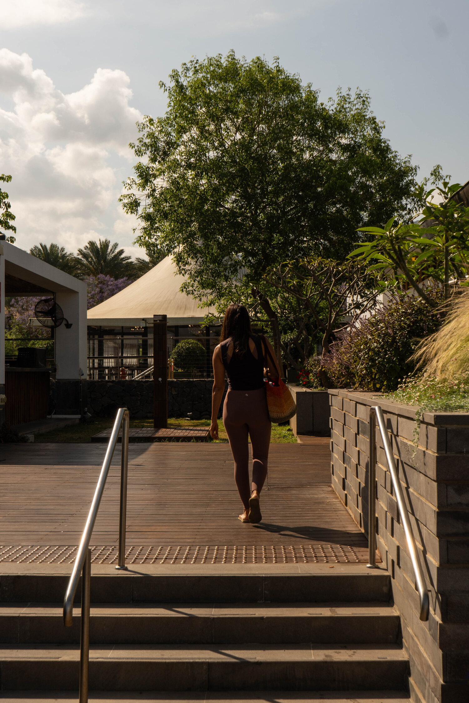 A guest walking down to the deck through the gardens