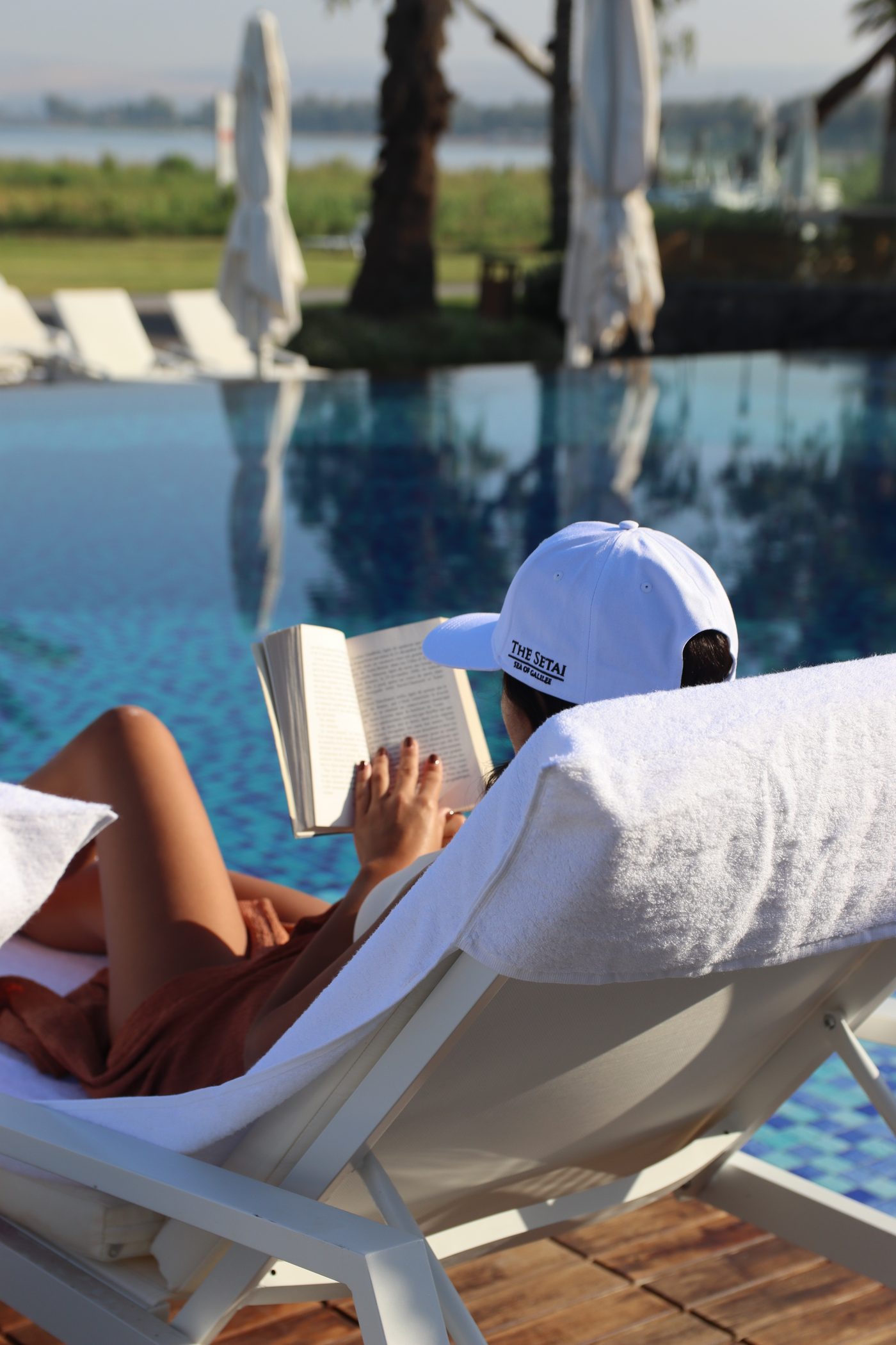 Reading on a lounger at the edge of the pool