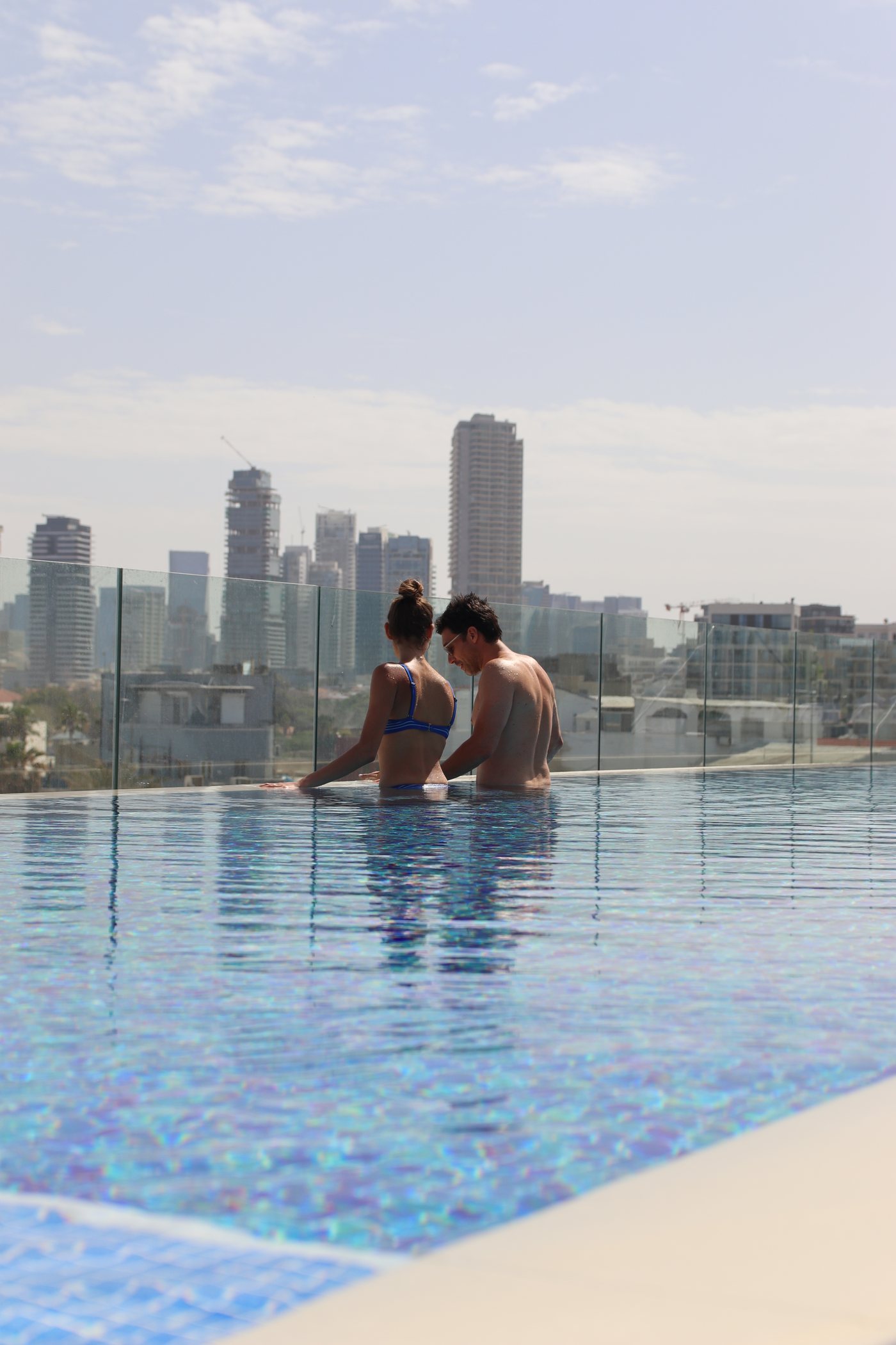 The rooftop pool, the city skyline beyond