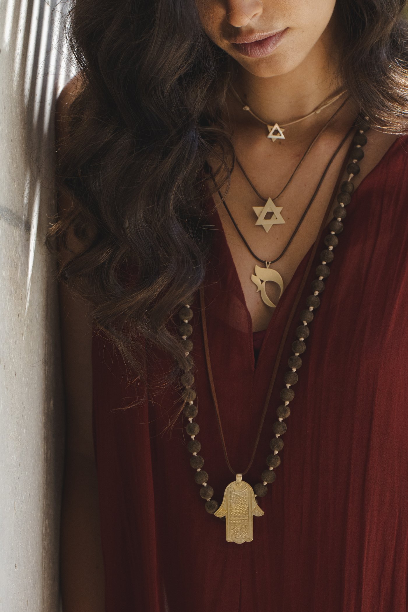 The hamsa against the pleats of the dress