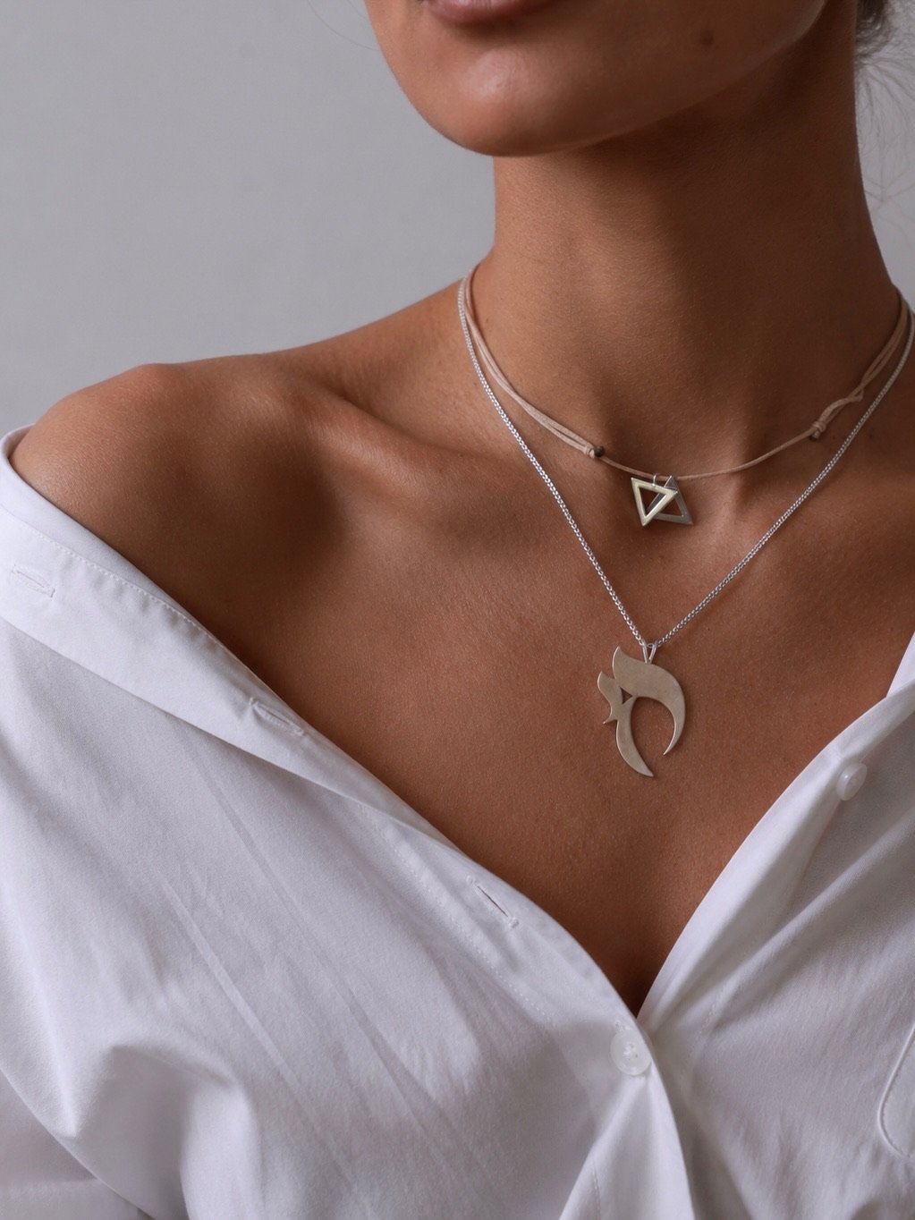 The crescent over an open white shirt